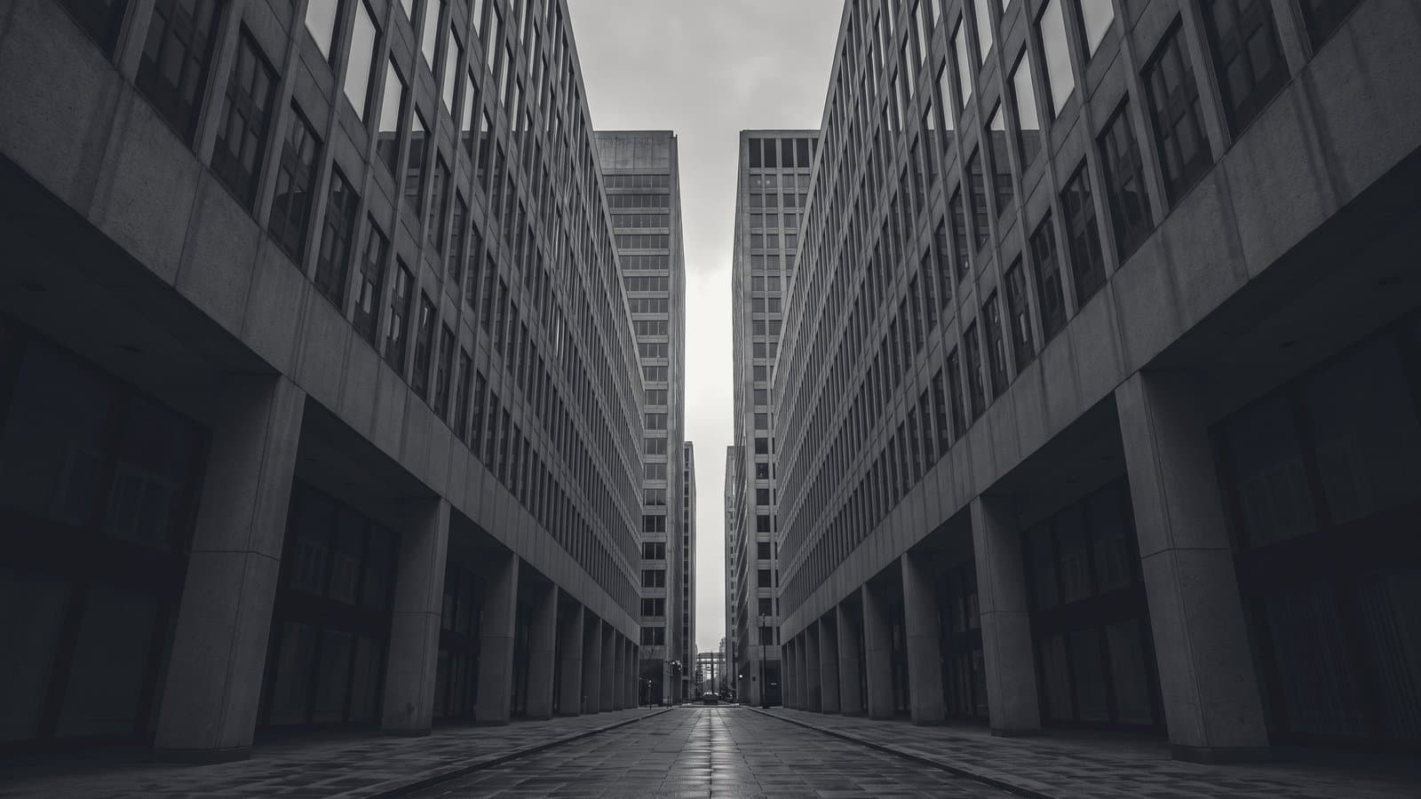 A narrow corridor of concrete towers receding into haze.