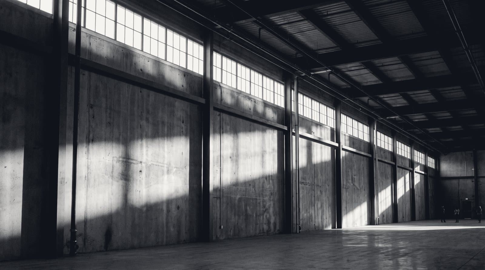 A continuous band of high clerestory windows along a bare industrial wall.