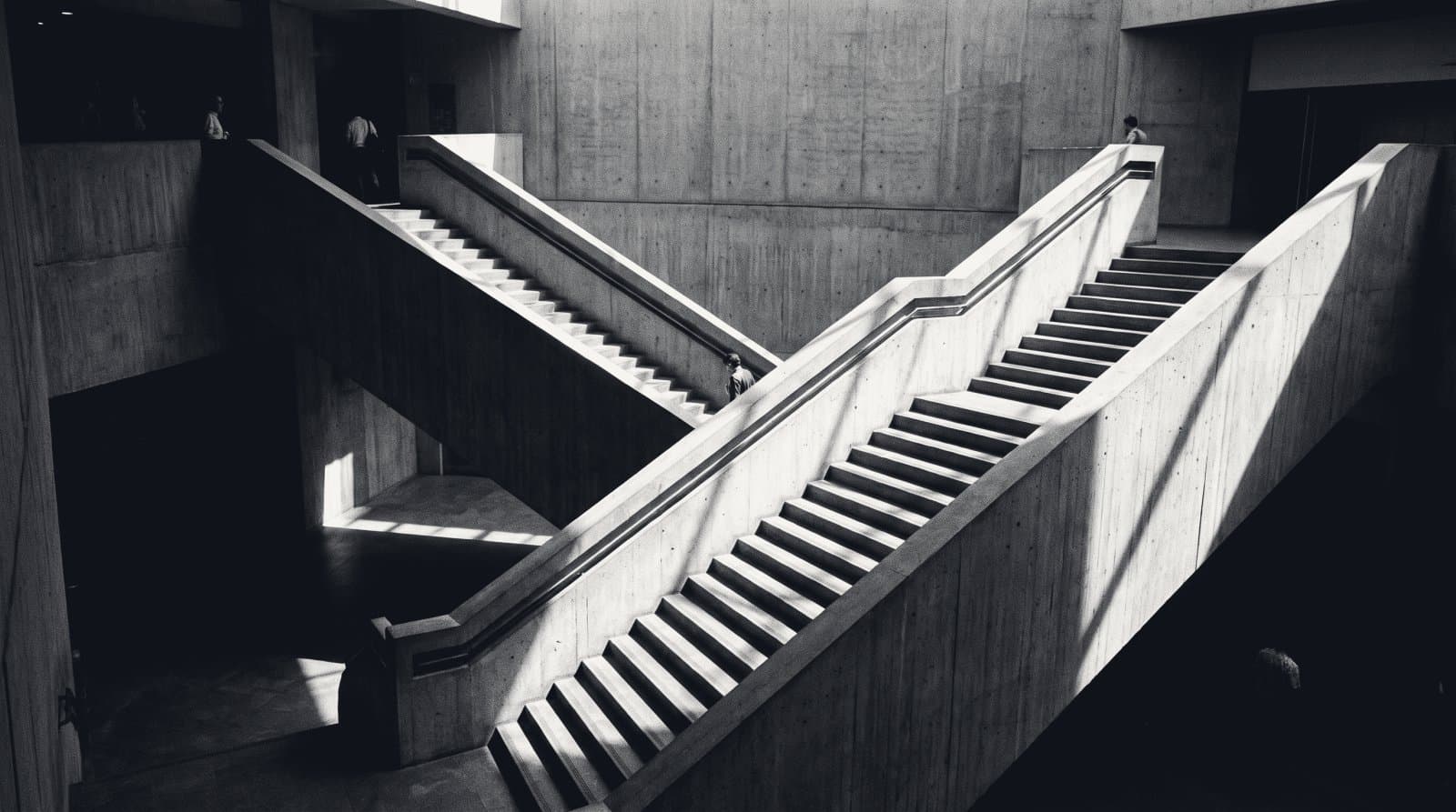 Two concrete staircases in one stairwell running in opposite directions.