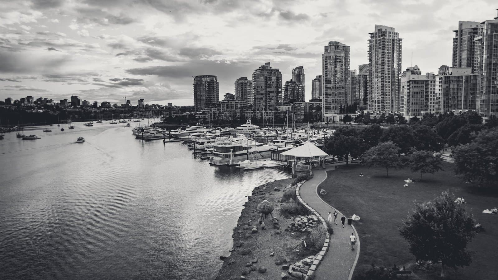 A shoreline path curving beneath residential towers.