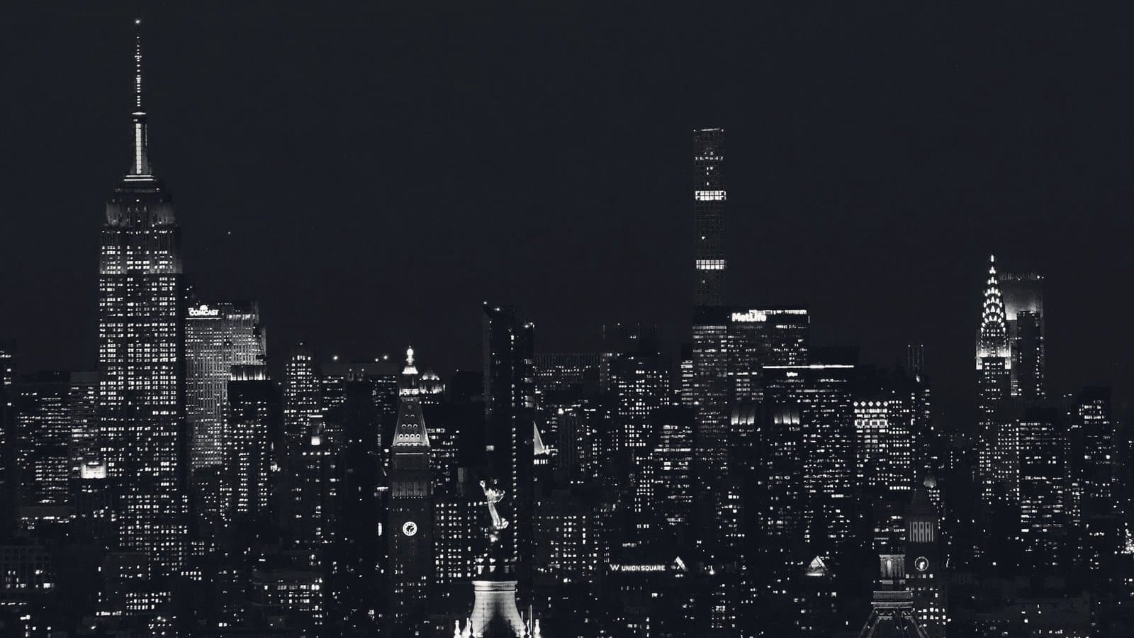 The Manhattan skyline at night in monochrome.