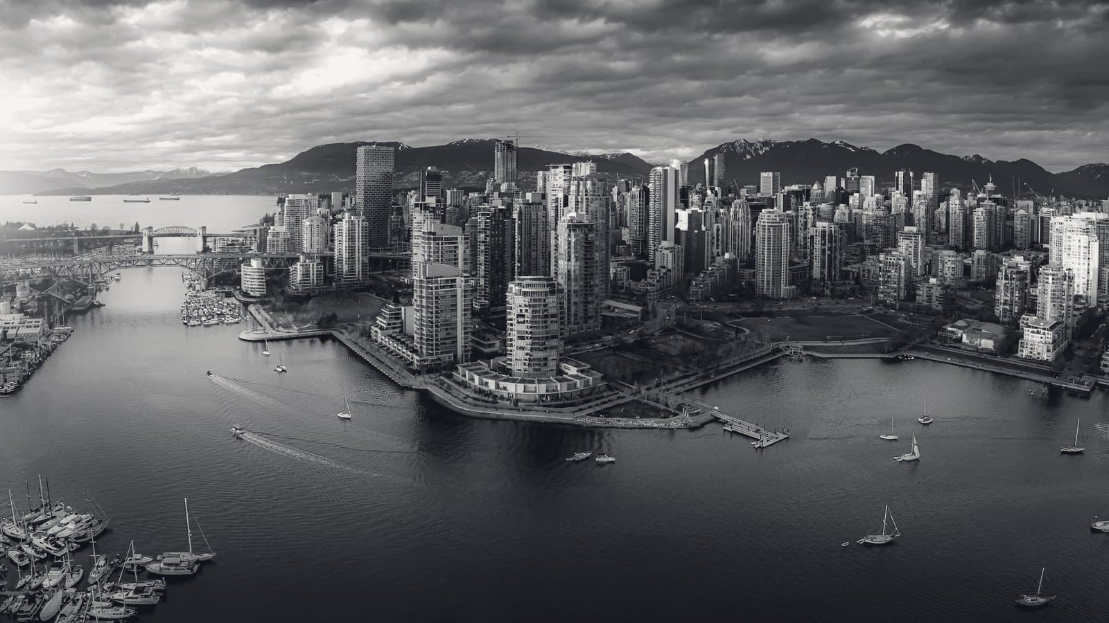 An aerial city at sunset, light splitting the frame.